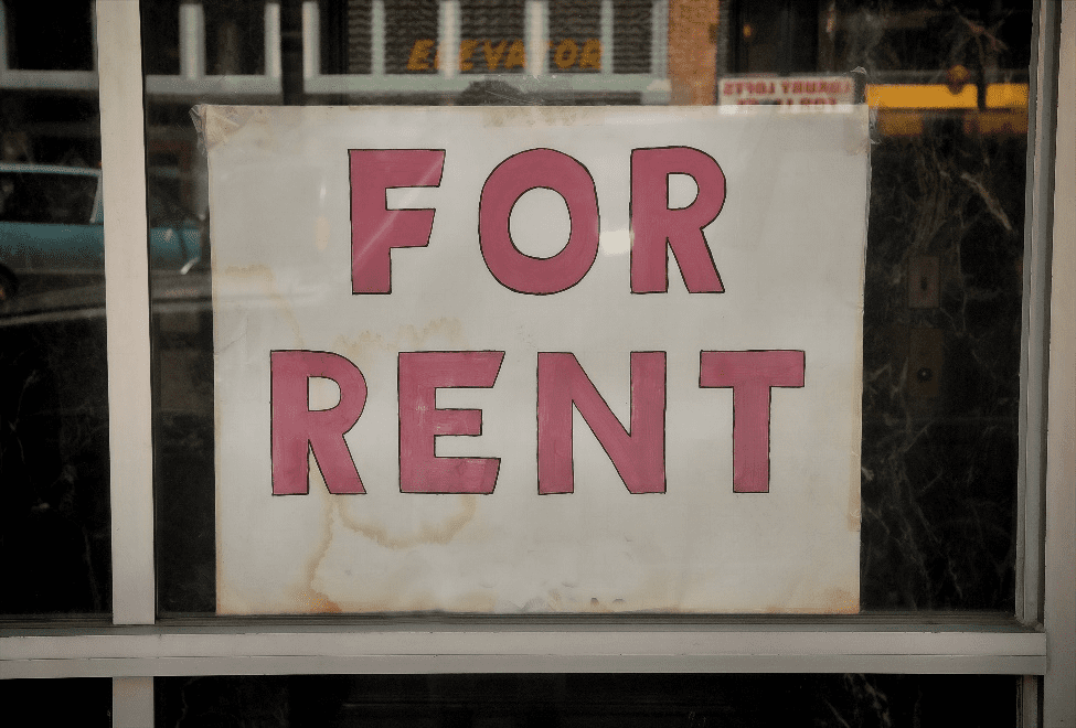 A window displaying a "for rent" sign.