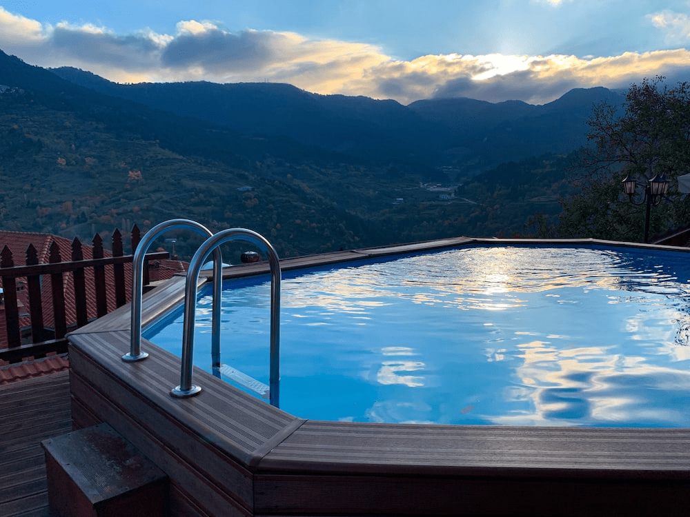 above-ground pool with trees and mountains
