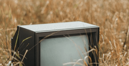 An old TV, leading to e-waste on the grass