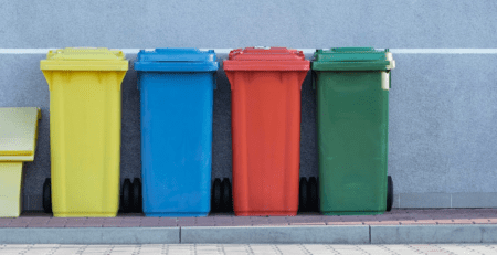 Different colored trash cans.