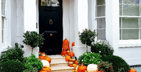 A house entrance decorated with pumpkins.